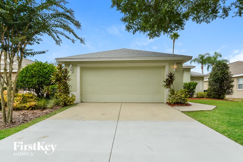 A house with a garage door and a driveway.