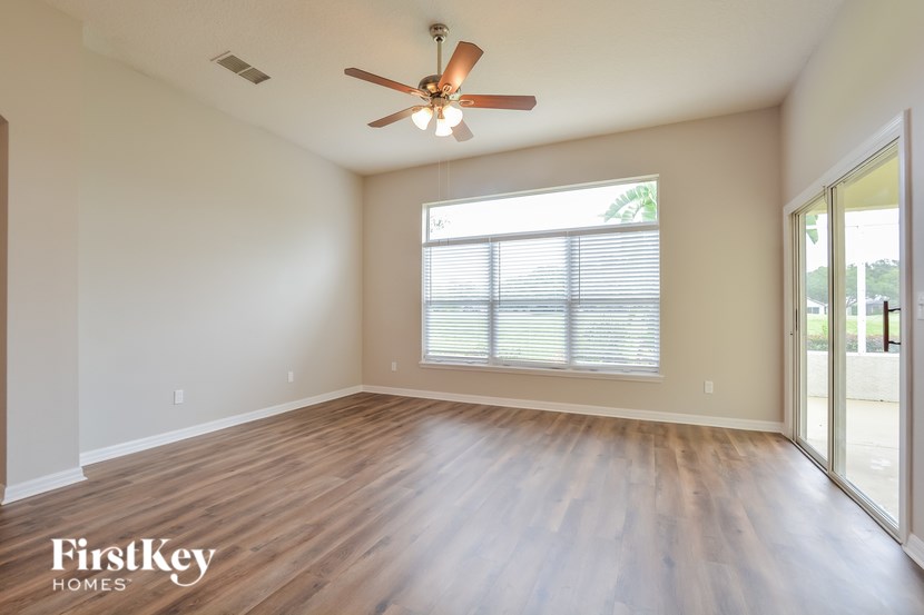 A room with wooden floors and a ceiling fan.