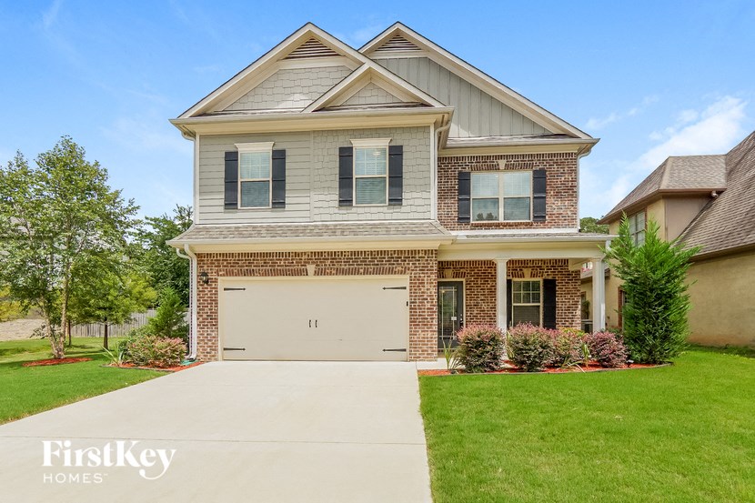 a large brick house with a white garage door