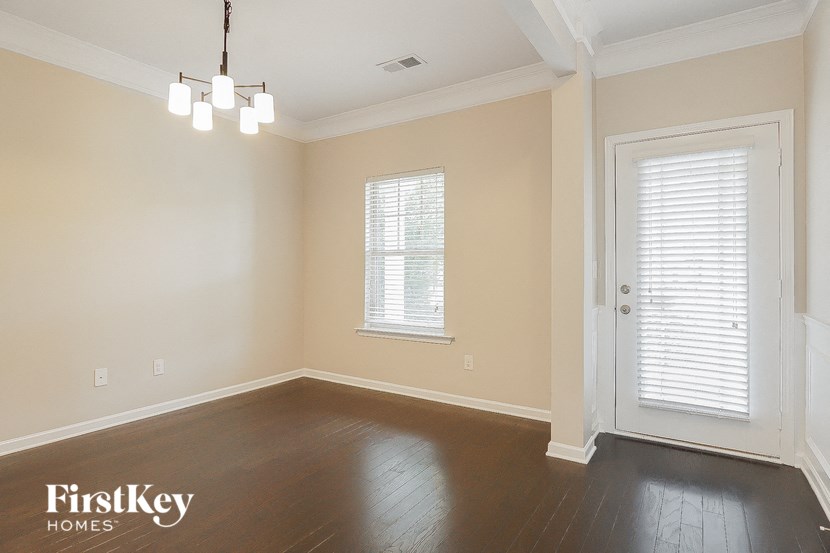 a empty living room with wood floors and a white door