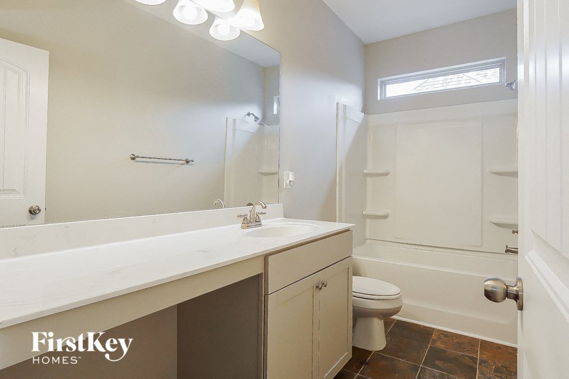 a bathroom with a sink and a toilet and a shower