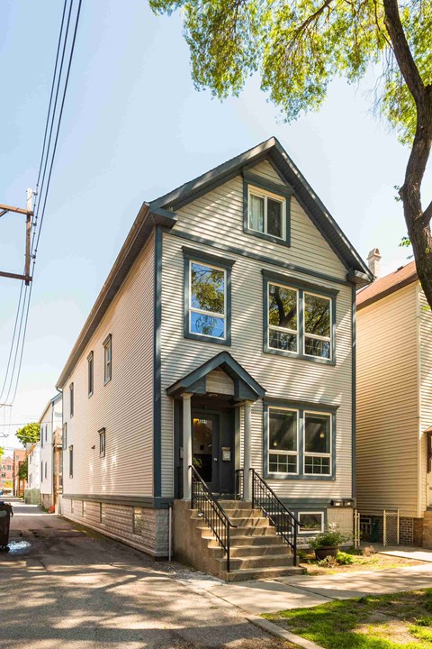 the exterior of a house with stairs and a sidewalk
