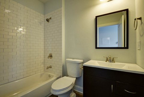 a bathroom with a sink toilet and bath tub