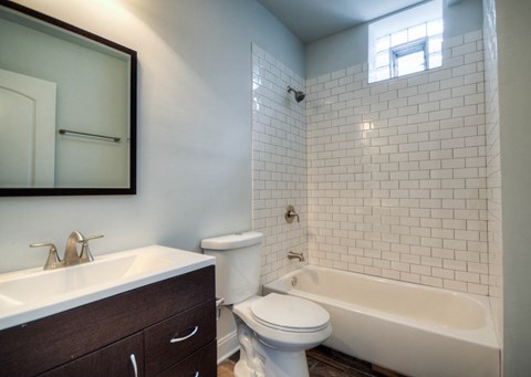a bathroom with a sink toilet and a tub