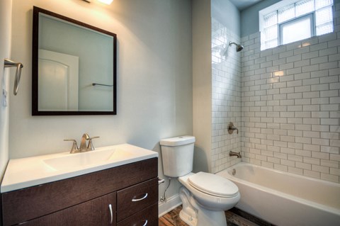 a bathroom with a toilet and a sink and a bath tub