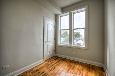 an empty room with a door and a window