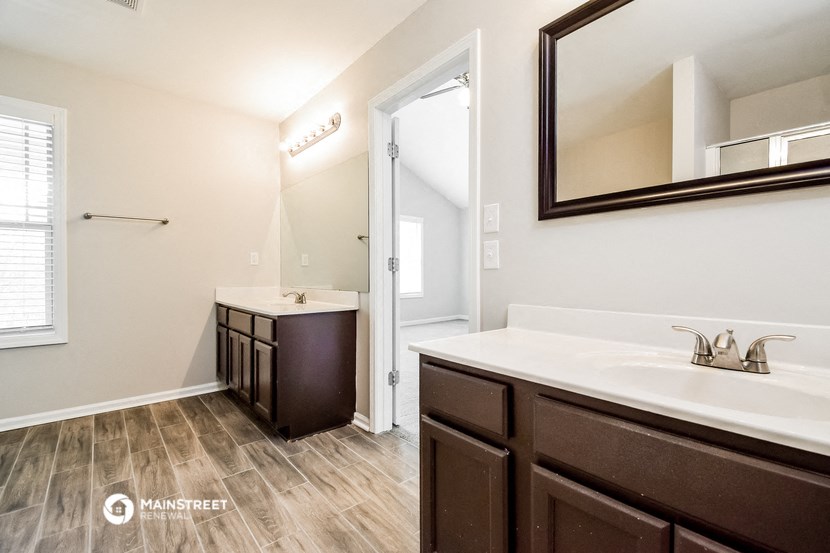 a bathroom with a sink and a mirror and a shower
