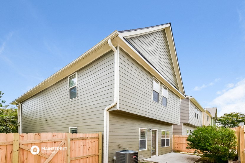 the exterior of a house with a wooden fence