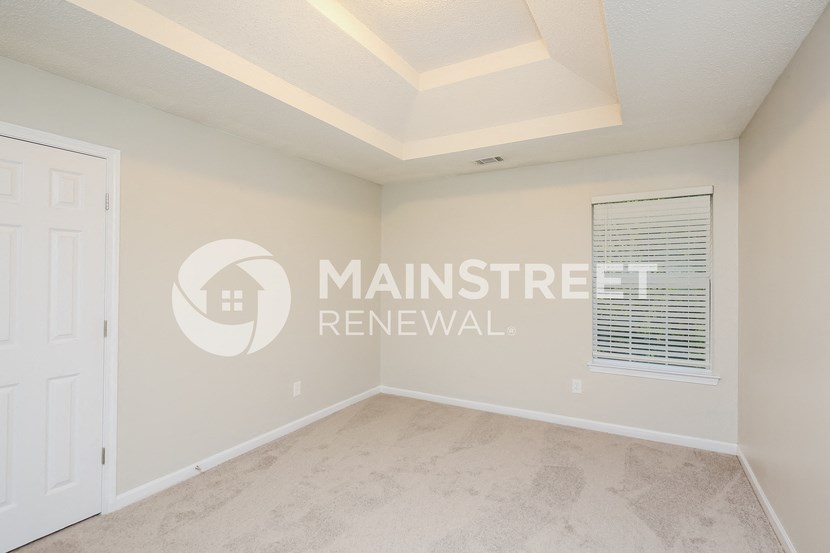 a bedroom with a large white closet and a window