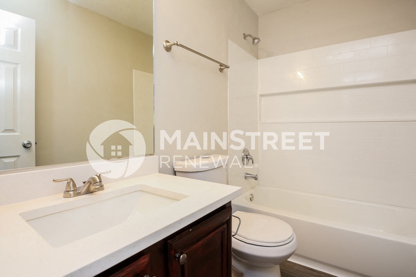 a bathroom with a sink and a toilet and a shower