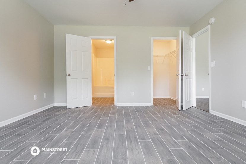 the living room of a new home with white doors and a gray tile floor