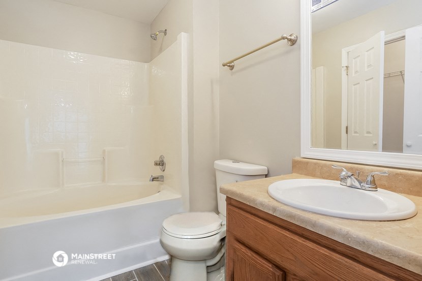 a bathroom with a sink toilet and a bath tub
