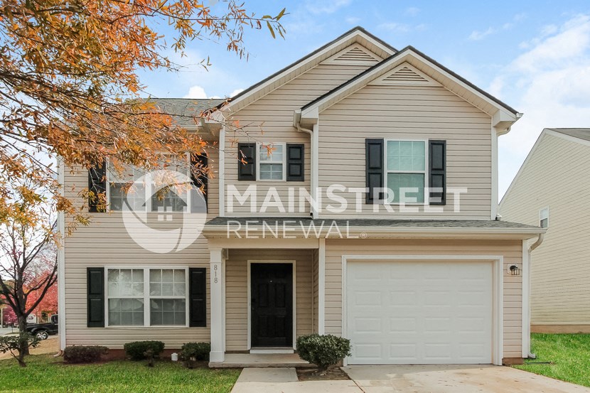 a single story house with a white garage door