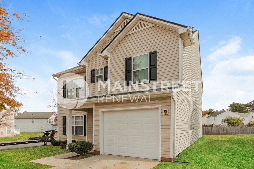 a house with a garage with a white door