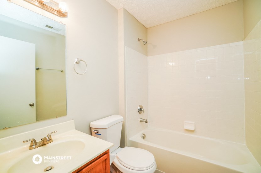 a bathroom with a sink toilet and a tub