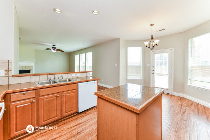 the kitchen and dining area are open to the living room