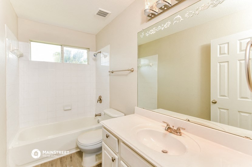 a bathroom with a sink and a toilet and a bath tub