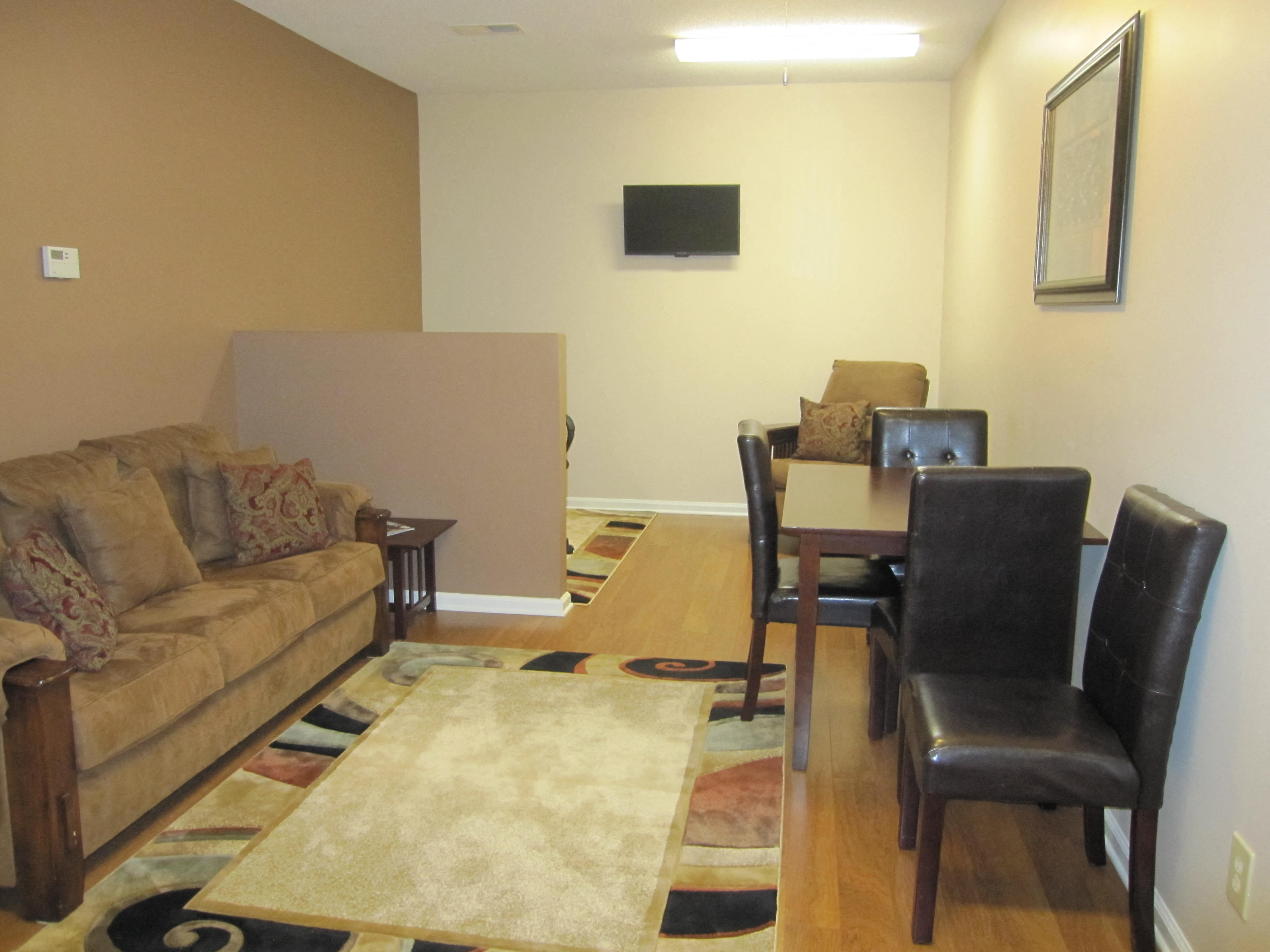 a living room and dining room with a couch and a table