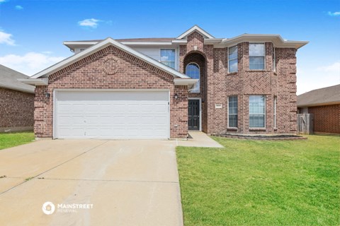 a large brick house with a white garage door