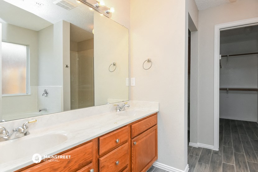 a bathroom with two sinks and a large mirror