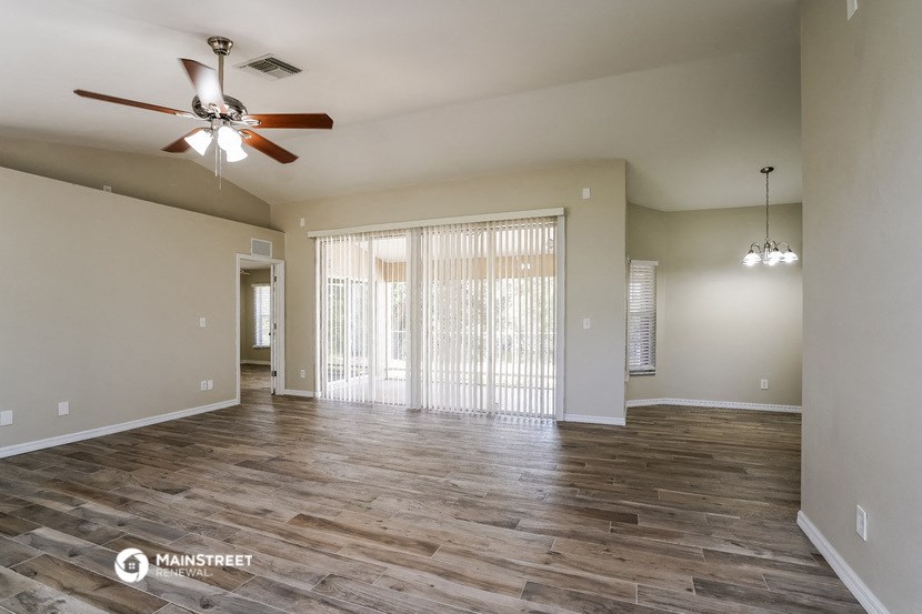 the spacious living room with sliding glass doors to the patio