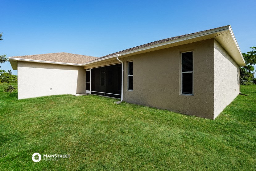 the backyard of a house with a lawn and a garage