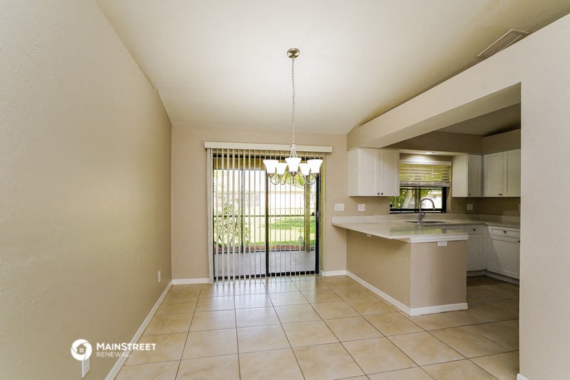 an open kitchen with a door to a patio