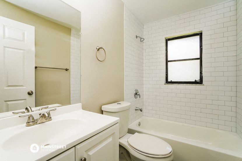 a bathroom with a sink toilet and a bath tub