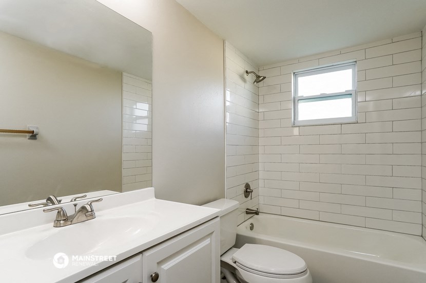 an empty bathroom with a sink toilet and tub