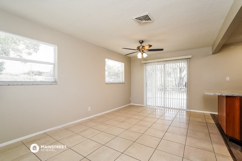 the living room is spacious and has a sliding glass door to the patio