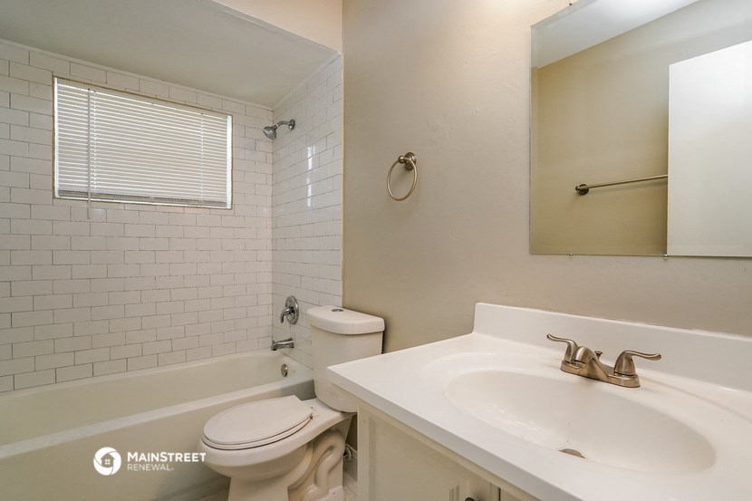 a bathroom with a sink and a toilet and a tub