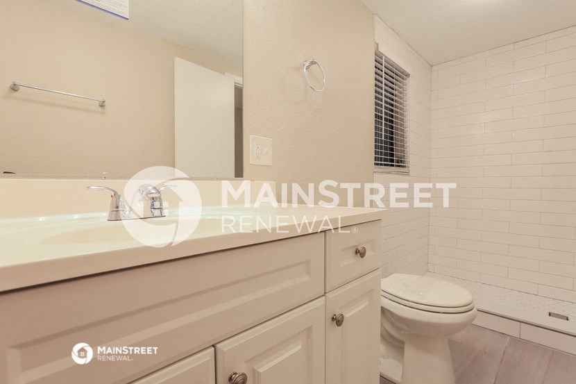 a white bathroom with a sink and a toilet