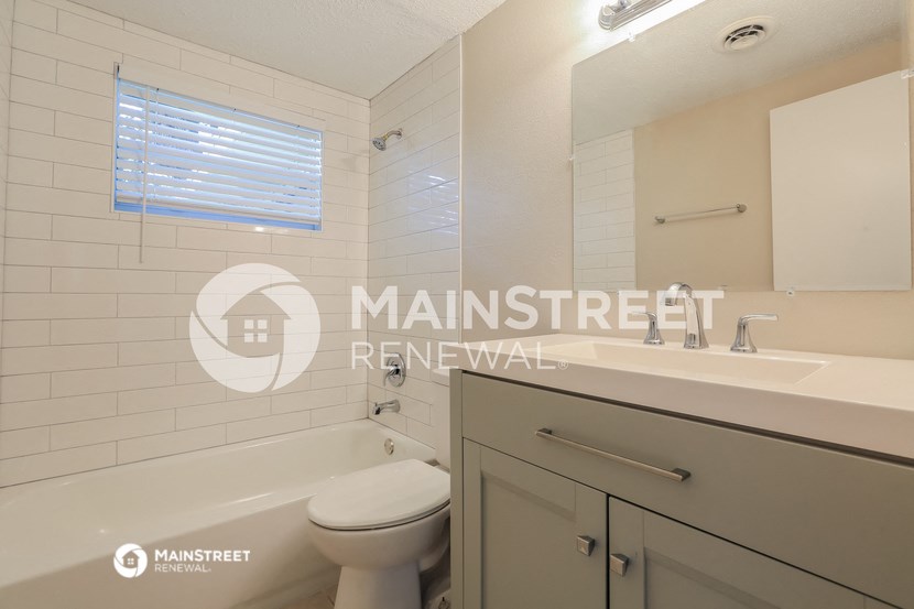 a bathroom with a sink and a toilet and a tub