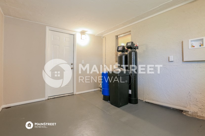 a room with two gas pumps in the corner of a room