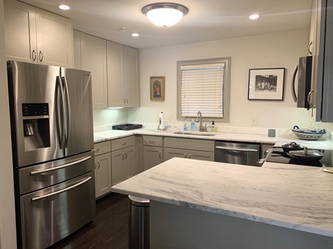 a kitchen with stainless steel appliances and a marble counter top