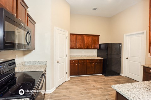 a kitchen with a stove and a refrigerator