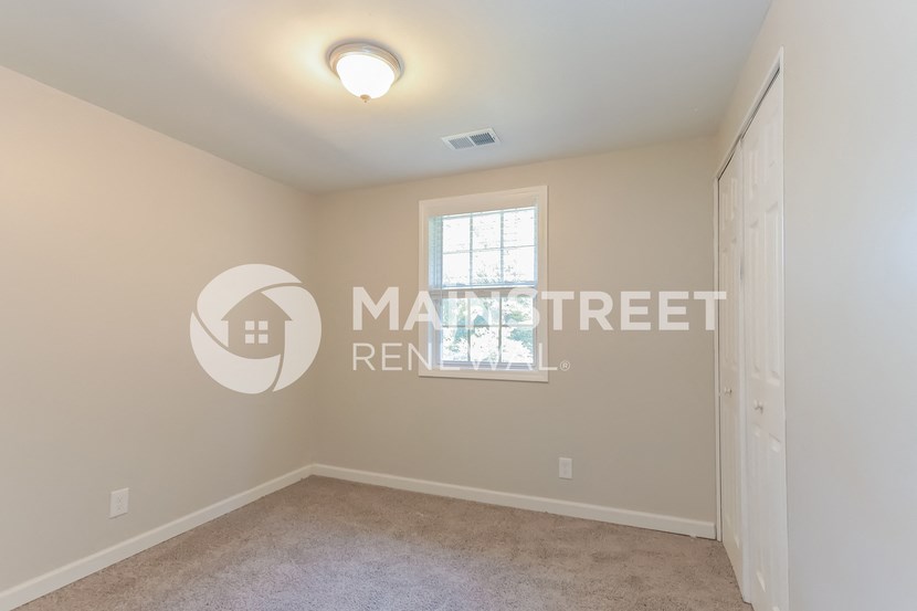 a bedroom with a closet and a window