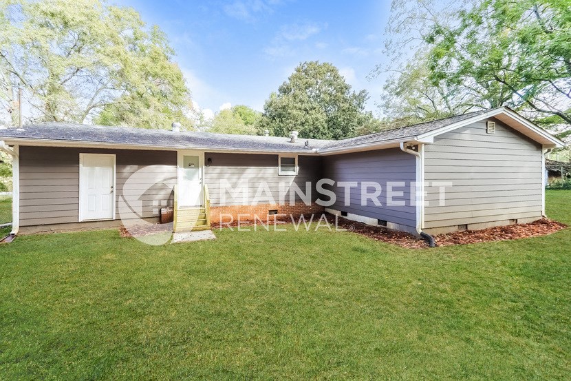 a small house with a lawn in front of it