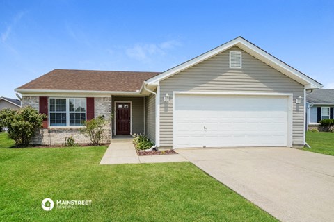 a house with a white garage door and a lawn