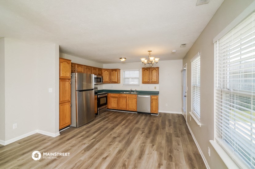 the kitchen of our studio apartment atrium with stainless steel appliances and wooden cabinets