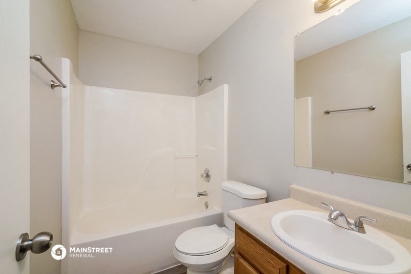 a bathroom with a sink and a toilet and a shower