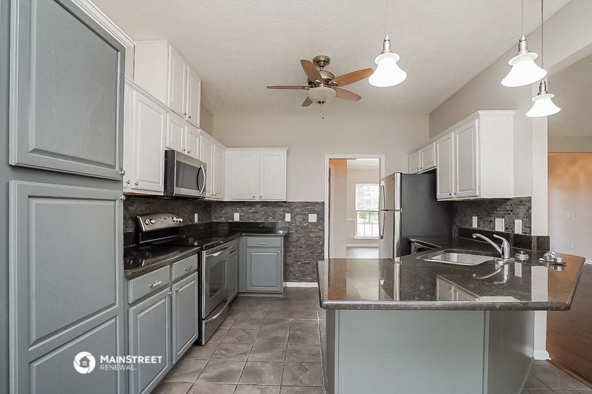 a kitchen with stainless steel appliances and a counter top