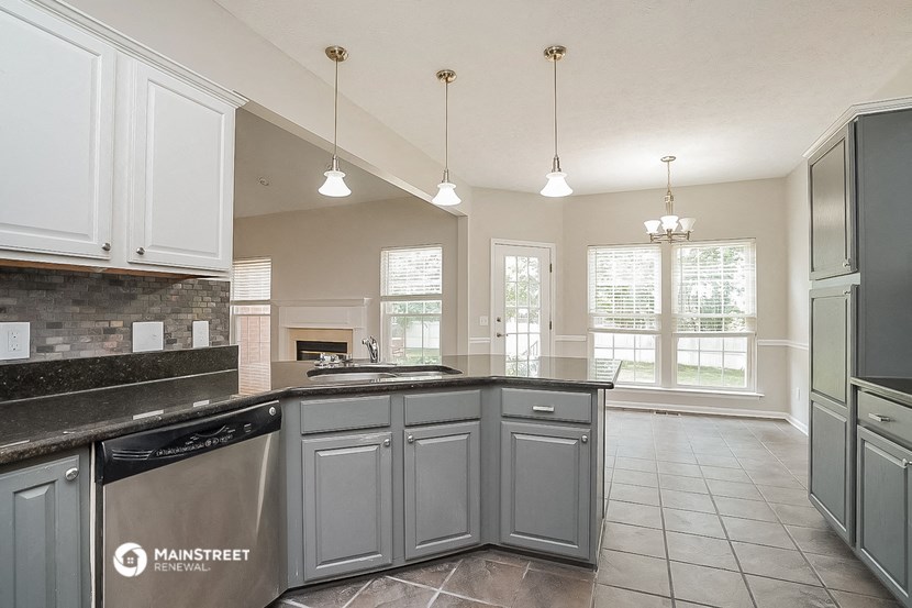 a kitchen with gray cabinets and a counter top
