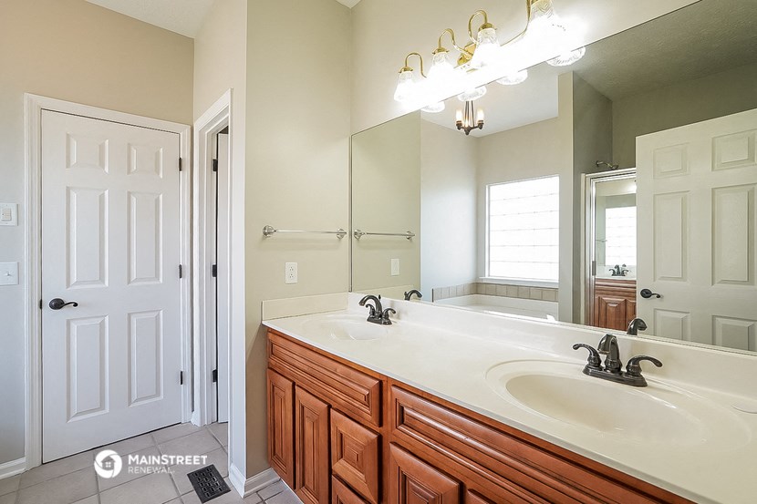 a bathroom with a sink and a mirror and a shower