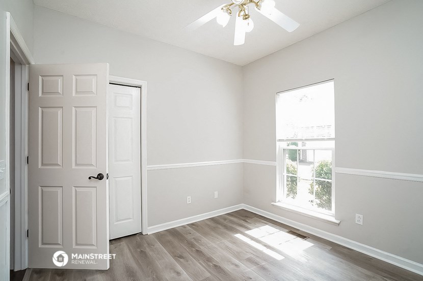 an empty room with white walls and a window