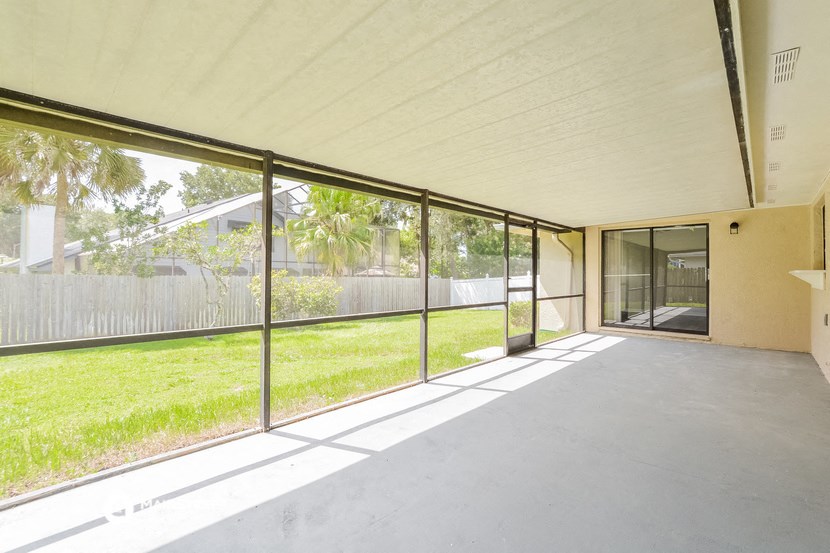 a large room with glass sliding doors and a yard