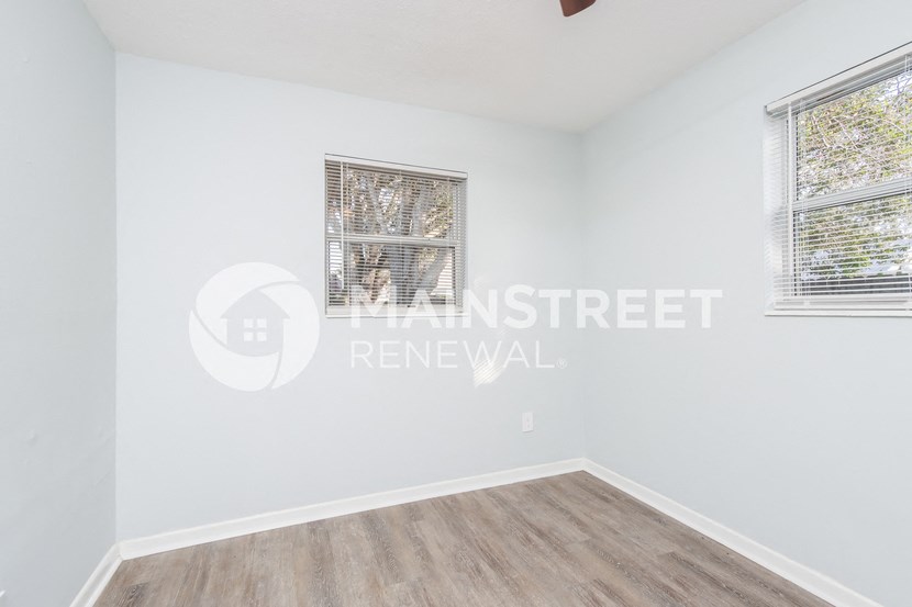 a room with white walls and a wooden floor