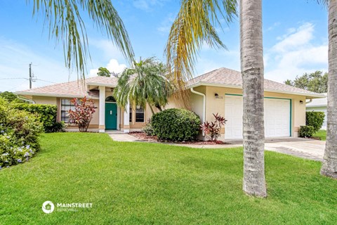 a house with palm trees in front of it