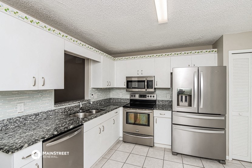 a kitchen with stainless steel appliances and granite counter tops