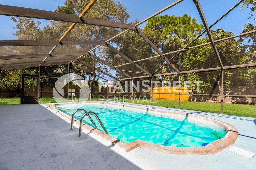 a resort style swimming pool in the backyard of a home